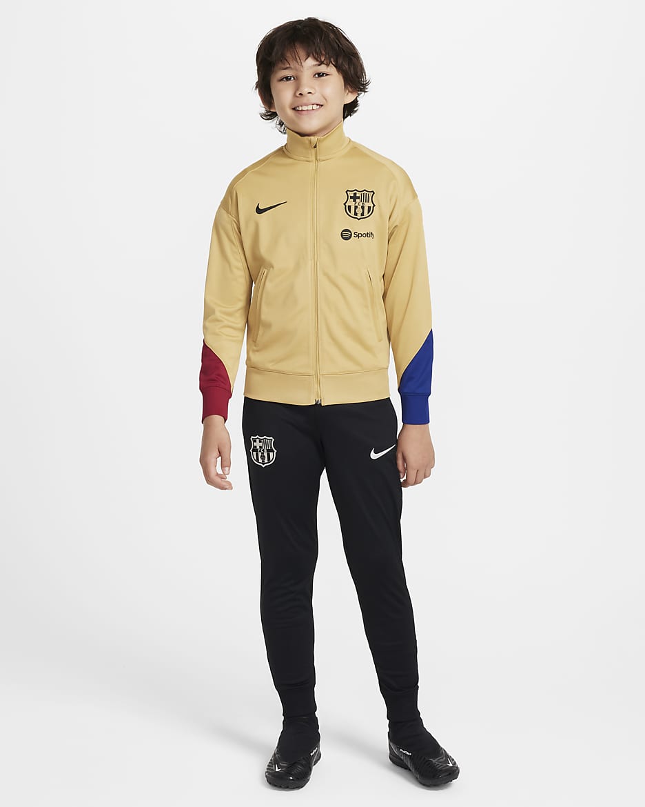 FC Barcelona Strike Nike Dri-FIT-Fußball-Trainingsanzug aus Strickmaterial für ältere Kinder - Club Gold/Noble Red/Deep Royal Blue/Schwarz