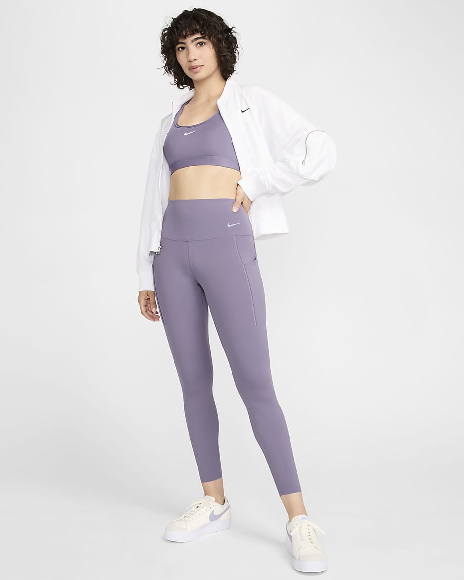 Leggings de 7/8 de tiro alto y sujeción media con bolsillos para mujer Nike Universa - Alba/Negro