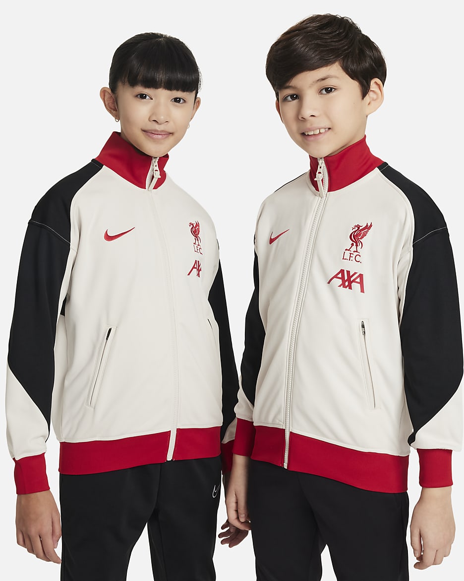 Liverpool FC Academy Pro Nike Dri-FIT voetbalvolksliedjack voor kids - Light Orewood Brown/Zwart/Gym Red