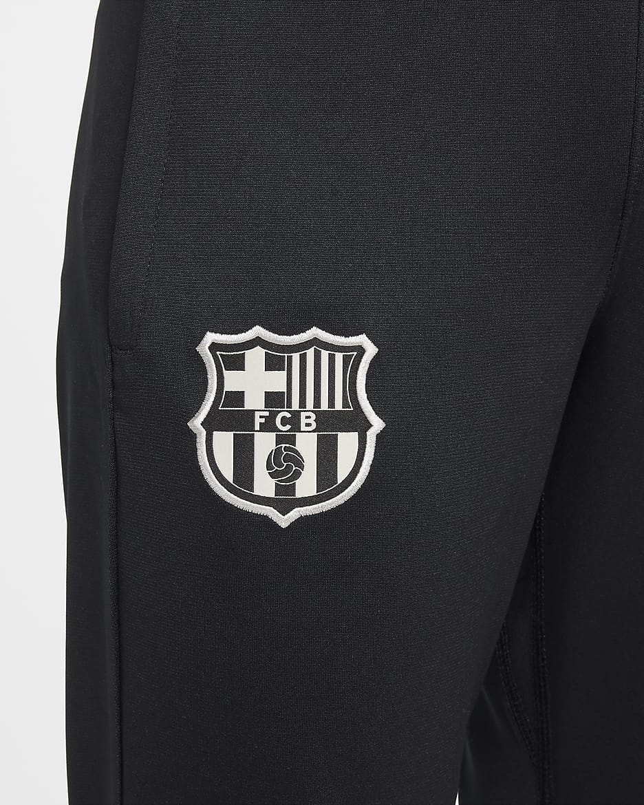 FC Barcelona Strike Nike Dri-FIT-Fußball-Trainingsanzug aus Strickmaterial für ältere Kinder - Club Gold/Noble Red/Deep Royal Blue/Schwarz