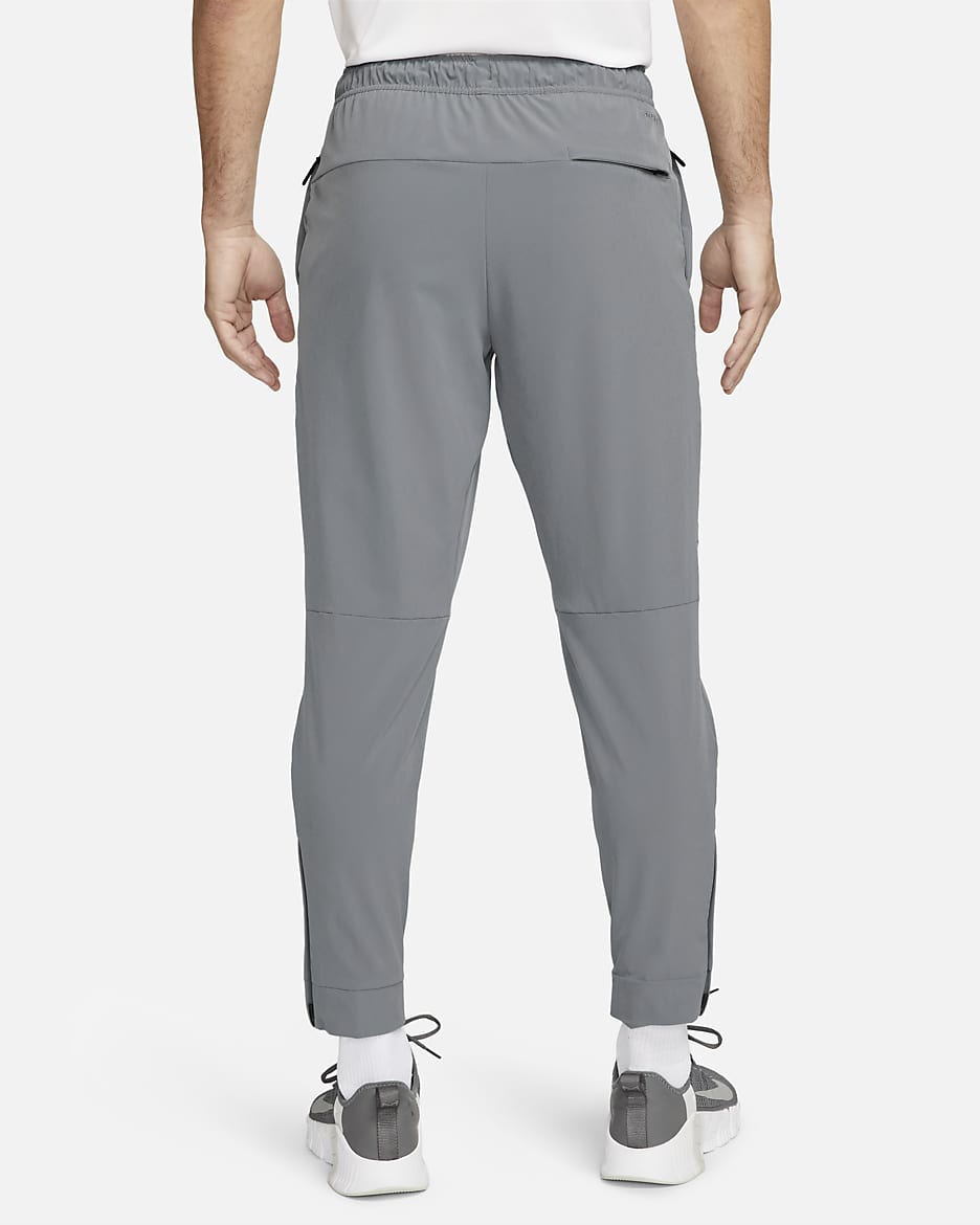 Nike Unlimited Pantalón versátil con bajos con cremallera Dri-FIT ADV - Hombre - Smoke Grey/Negro/Smoke Grey