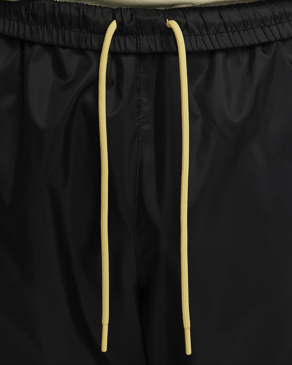 Nike Windrunner vevd bukse med fôr til herre - Svart/Dark Stucco/Saturn Gold