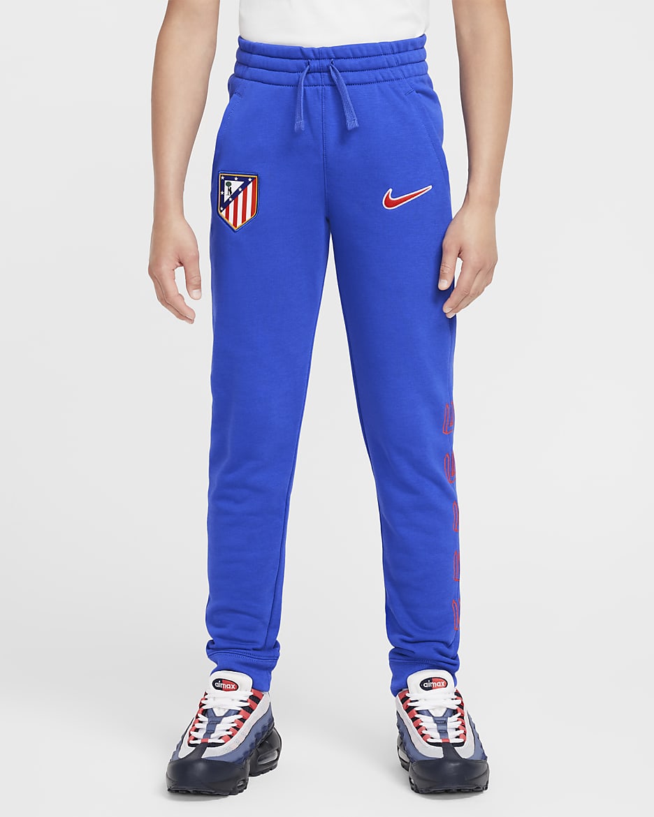 Atlético Madrid Club Thuis Nike voetbaljoggingbroek van sweatstof voor jongens - Game Royal/Light Crimson