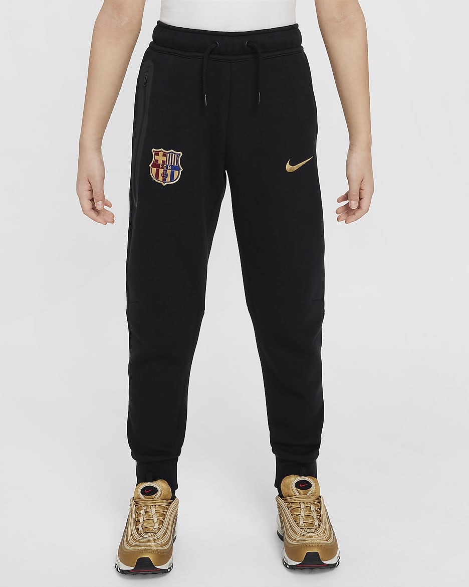 FC Barcelona Tech Fleece Nike-fodboldbukser til større børn (drenge) - sort/Club Gold