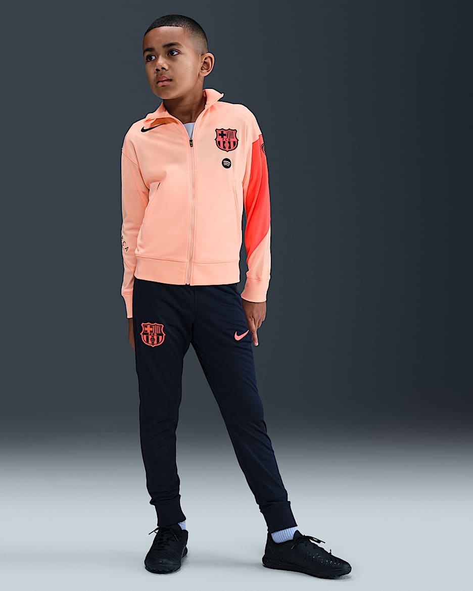 F.C. Barcelona Strike Third Older Kids' Nike Dri-FIT Total 90 Football Knit Tracksuit - Crimson Tint/Midnight Navy/Bright Mango/Midnight Navy