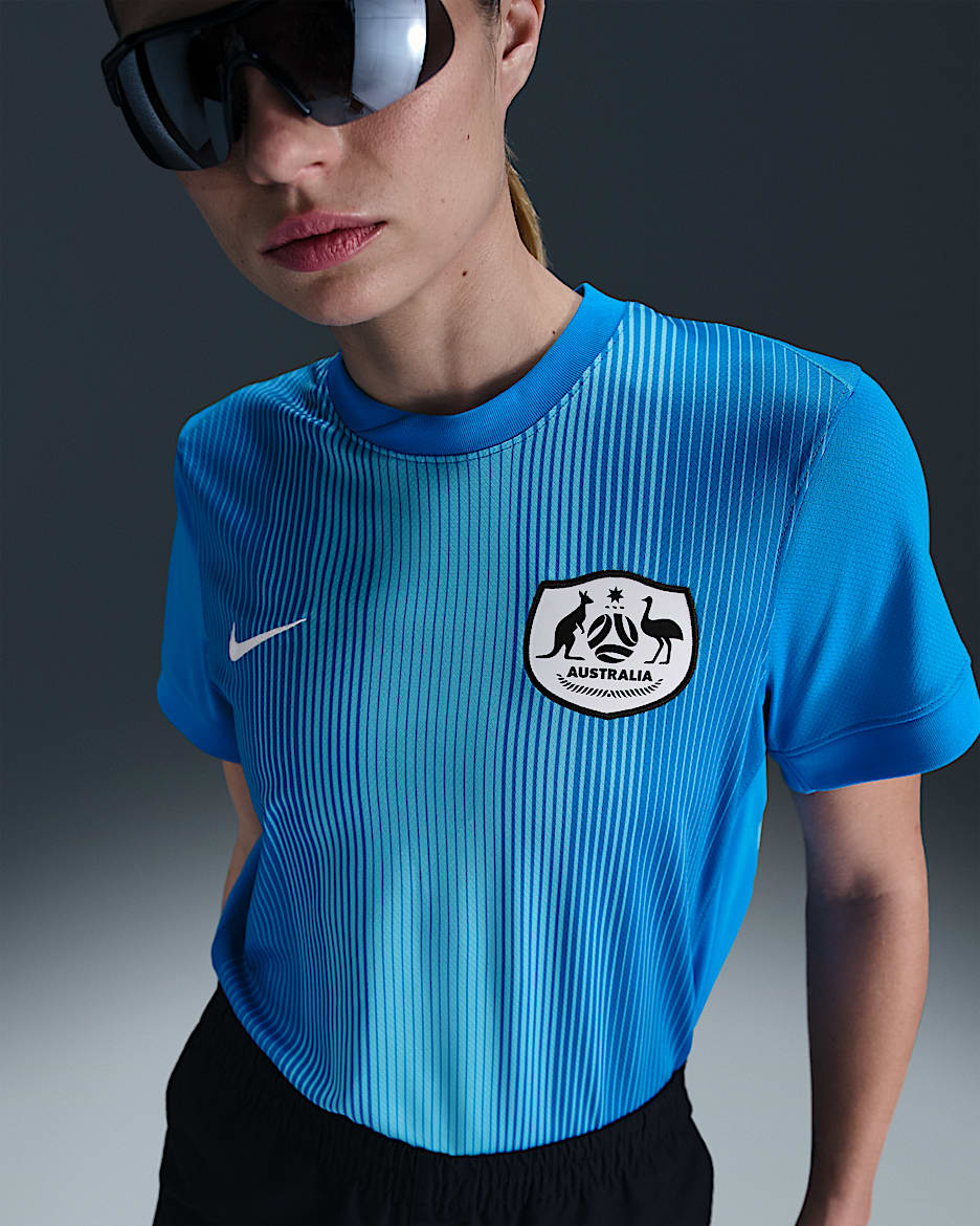 Replika dámského brankářského fotbalového dresu Nike Dri-FIT Austrálie Stadium 2025/26 s krátkým rukávem - Photo Blue/Baltic Blue/Bílá