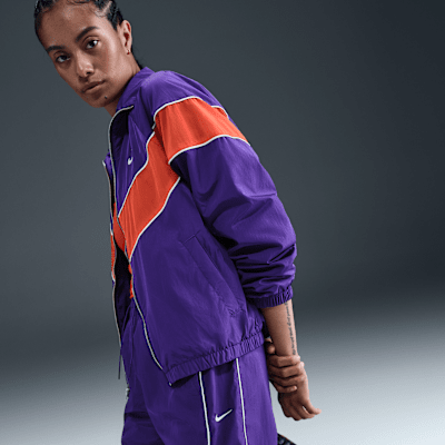 Pantaloni in tessuto a vita alta con bordo aperto Nike Windrunner – Donna
