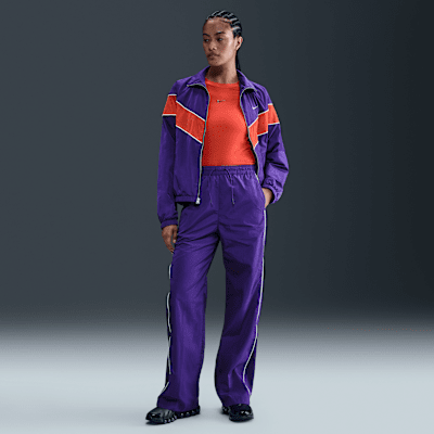 Pantaloni in tessuto a vita alta con bordo aperto Nike Windrunner – Donna