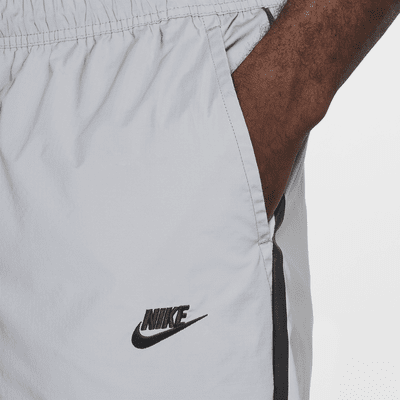 Pantaloni in tessuto con design rifrangente Nike Tech – Uomo