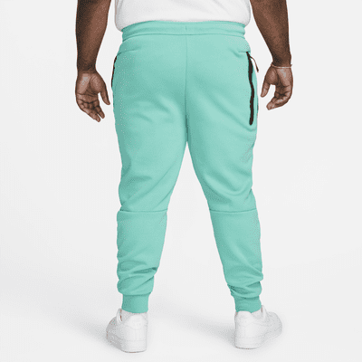 orange nike tech joggers