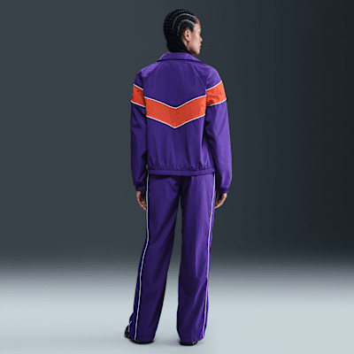 Pantaloni in tessuto a vita alta con bordo aperto Nike Windrunner – Donna