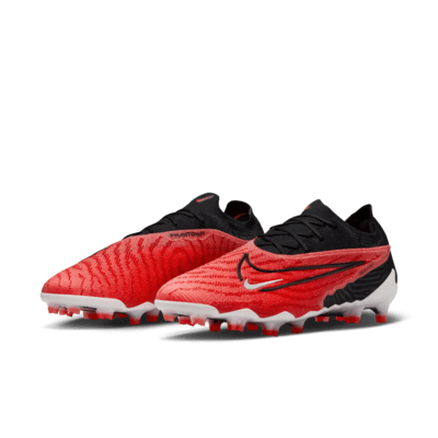 Tacos de fútbol de corte low para terreno firme Nike Phantom GX Elite