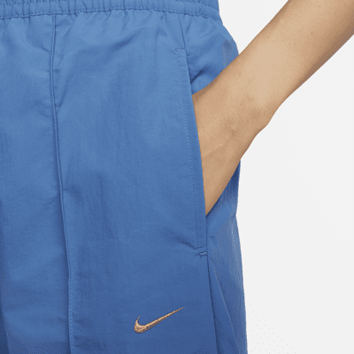 Pantaloni a vita media con bordo aperto Nike Sportswear Everything Wovens – Donna