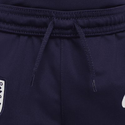 Maskinstrikket England Strike Nike Dri-FIT-fodboldtracksuit til mindre børn