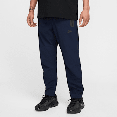 Pantaloni in tessuto con bordo aperto Nike Tech – Uomo