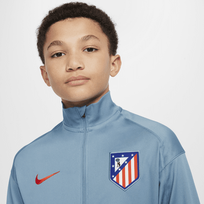 Pleteninová fotbalová tepláková souprava Nike Dri-FIT Atlético Madrid Strike pro větší děti