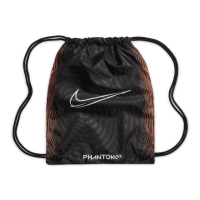 Tacos de fútbol de corte low para terreno firme Nike Phantom GX Elite