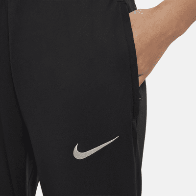 Dzianinowe spodnie piłkarskie dla dużych dzieci Nike Dri-FIT Liverpool F.C. Strike