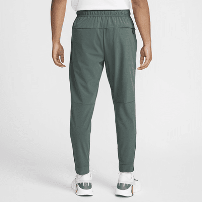 Mångsidiga byxor Nike Unlimited Dri-FIT med mudd med dragkedja för män