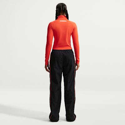 Pantalon taille haute à ourlet ouvert Nike Football Chelsea FC Windrunner pour femme