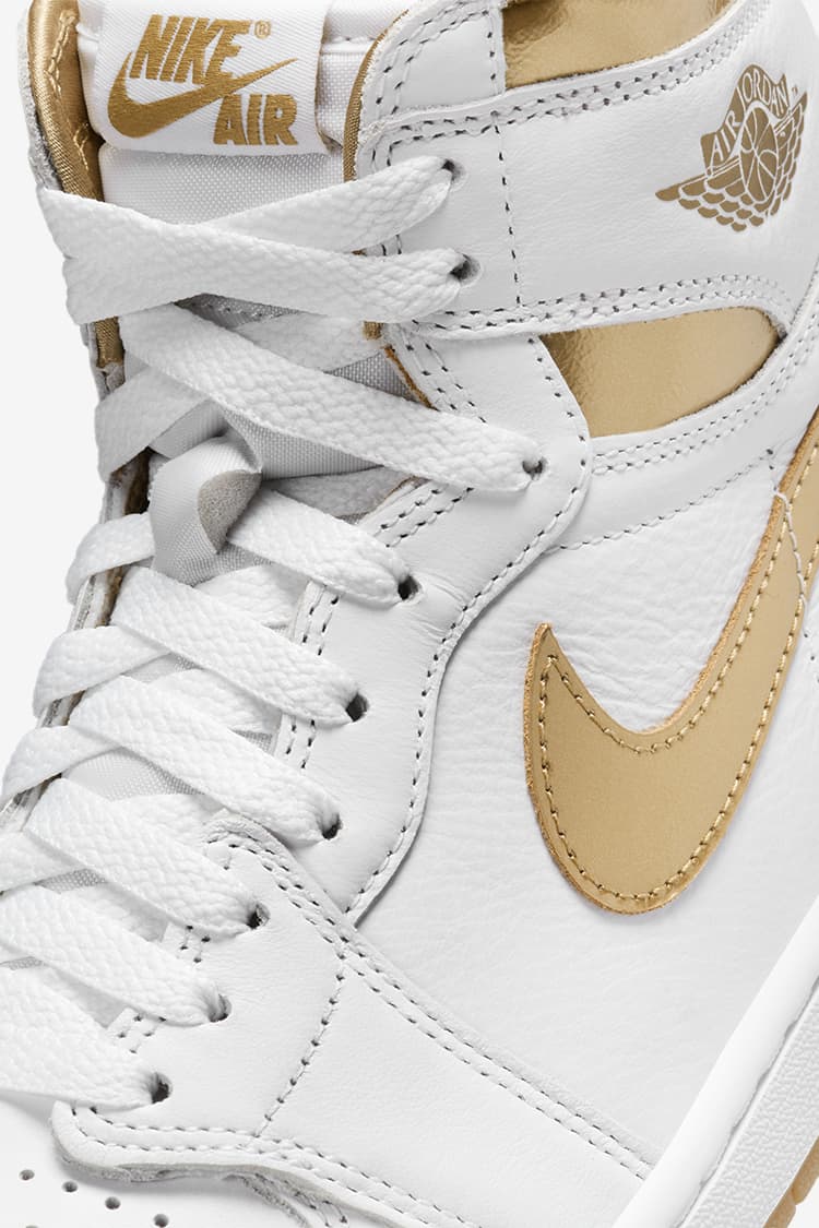white and gold nike shoes