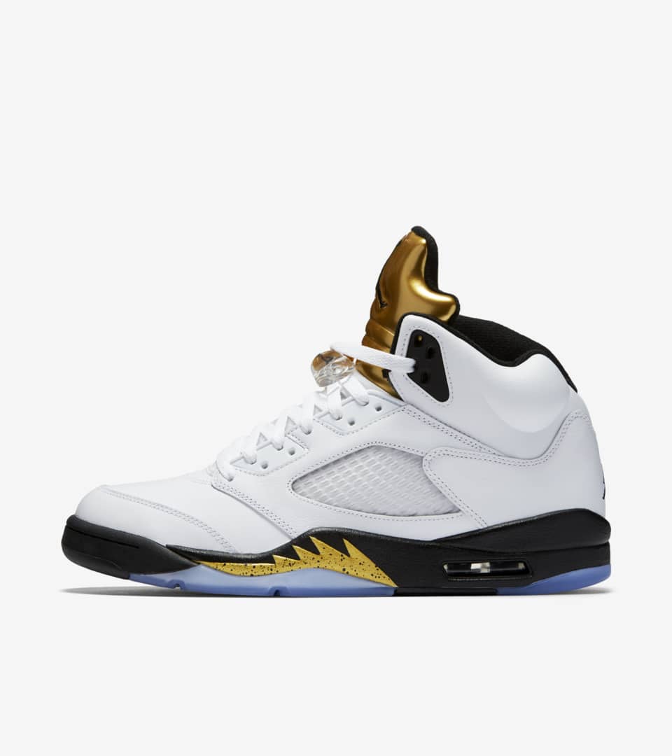 White jordans best sale with gold logo