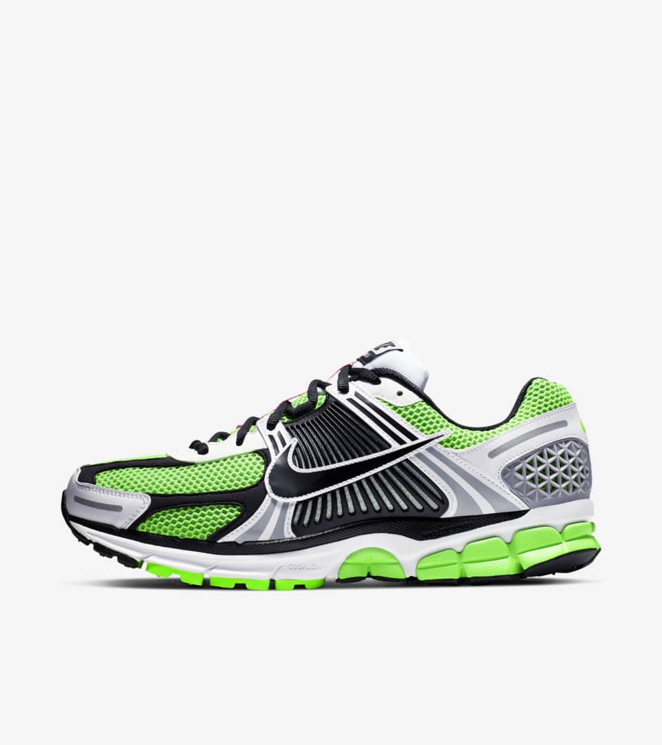 Left lateral view of the men's Nike Zoom Vomero 5 low-top running shoe in Electric Green and White, featuring a Zoom midsole and a black logo with metallic silver accents.