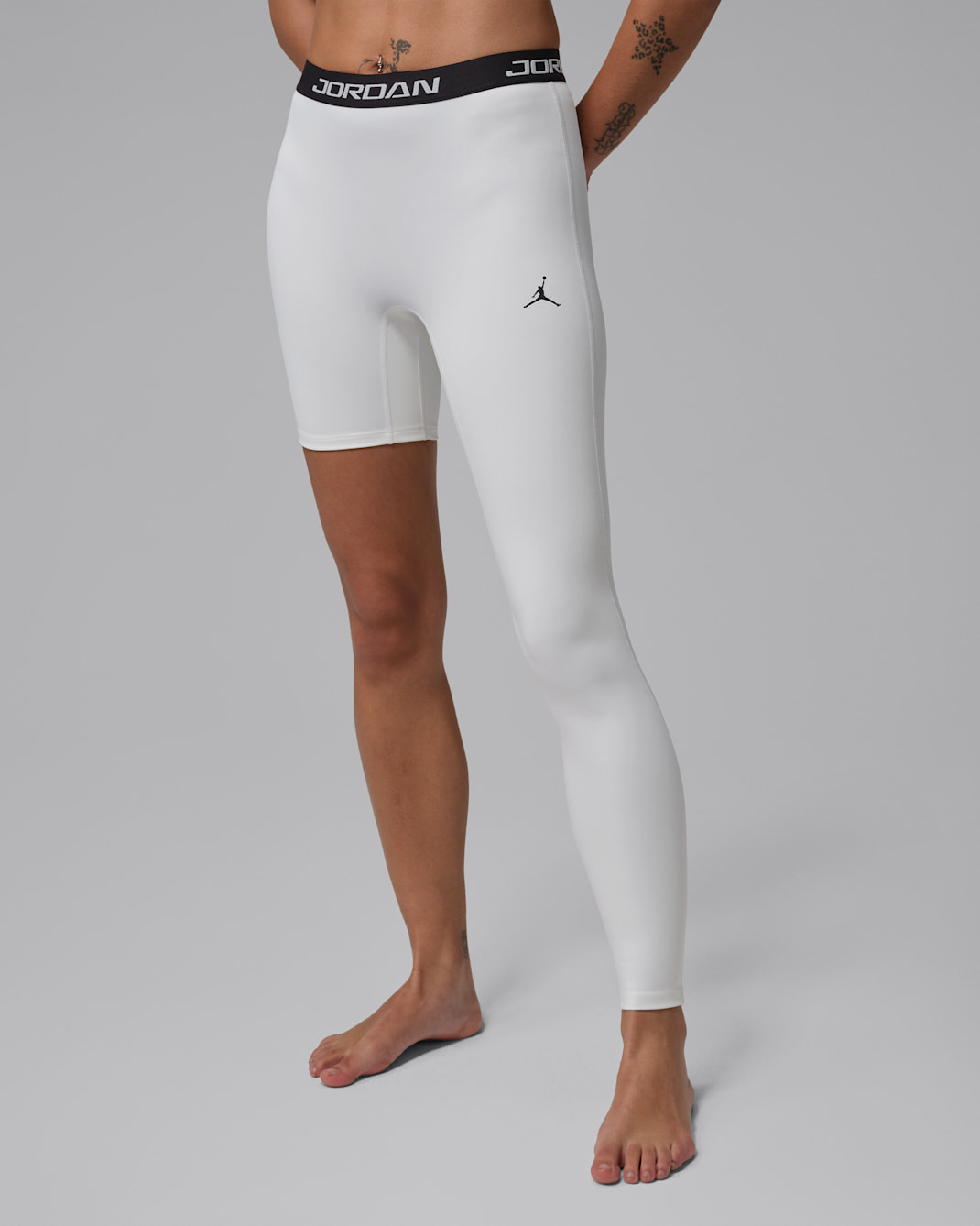 Jordan Sport basketballegging met hoge taille en enkele pijp voor dames (links) - Wit/Zwart