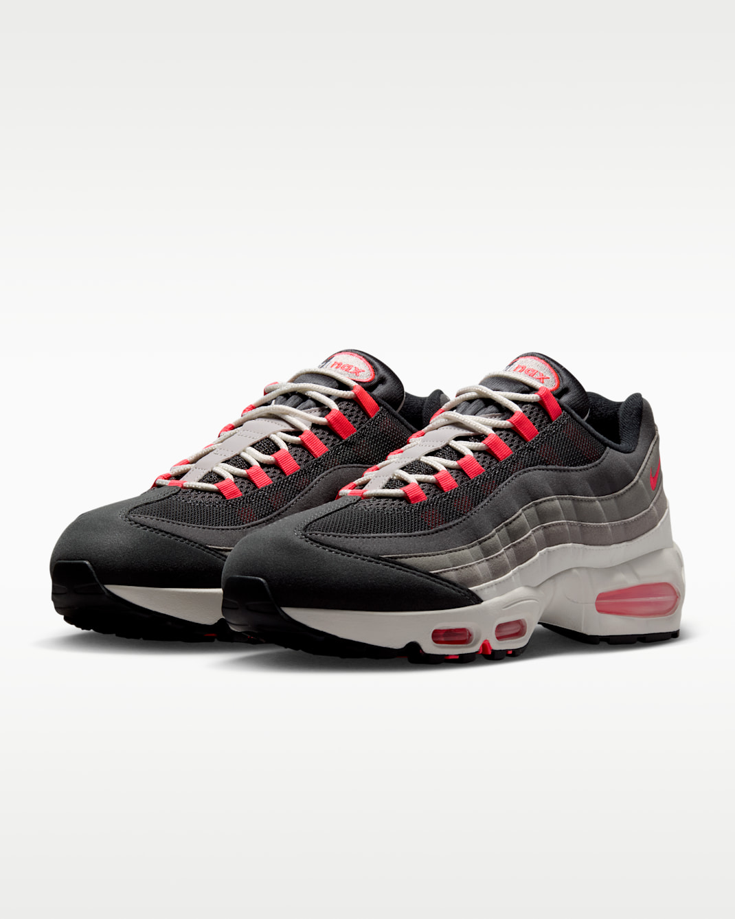 Nike Air Max 95 Reverse Solar Red IV6425-060 hero image showing inverted greyscale gradient with dark top panels fading to white midsole and Solar Red accents