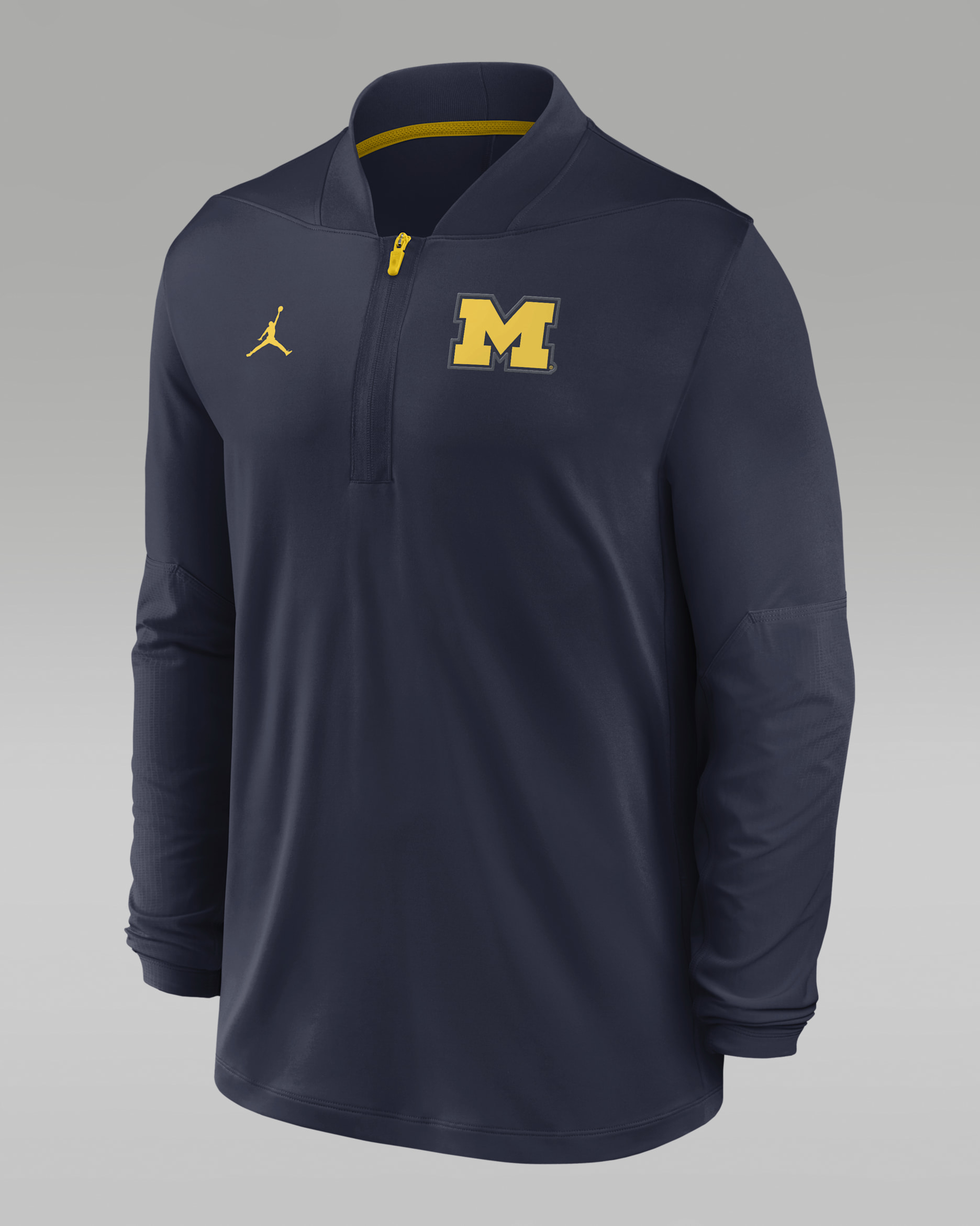 Playera universitaria marca Jordan Dri-FIT de medio cierre para hombre Michigan Sideline - Azul marino universitario/Amarillo