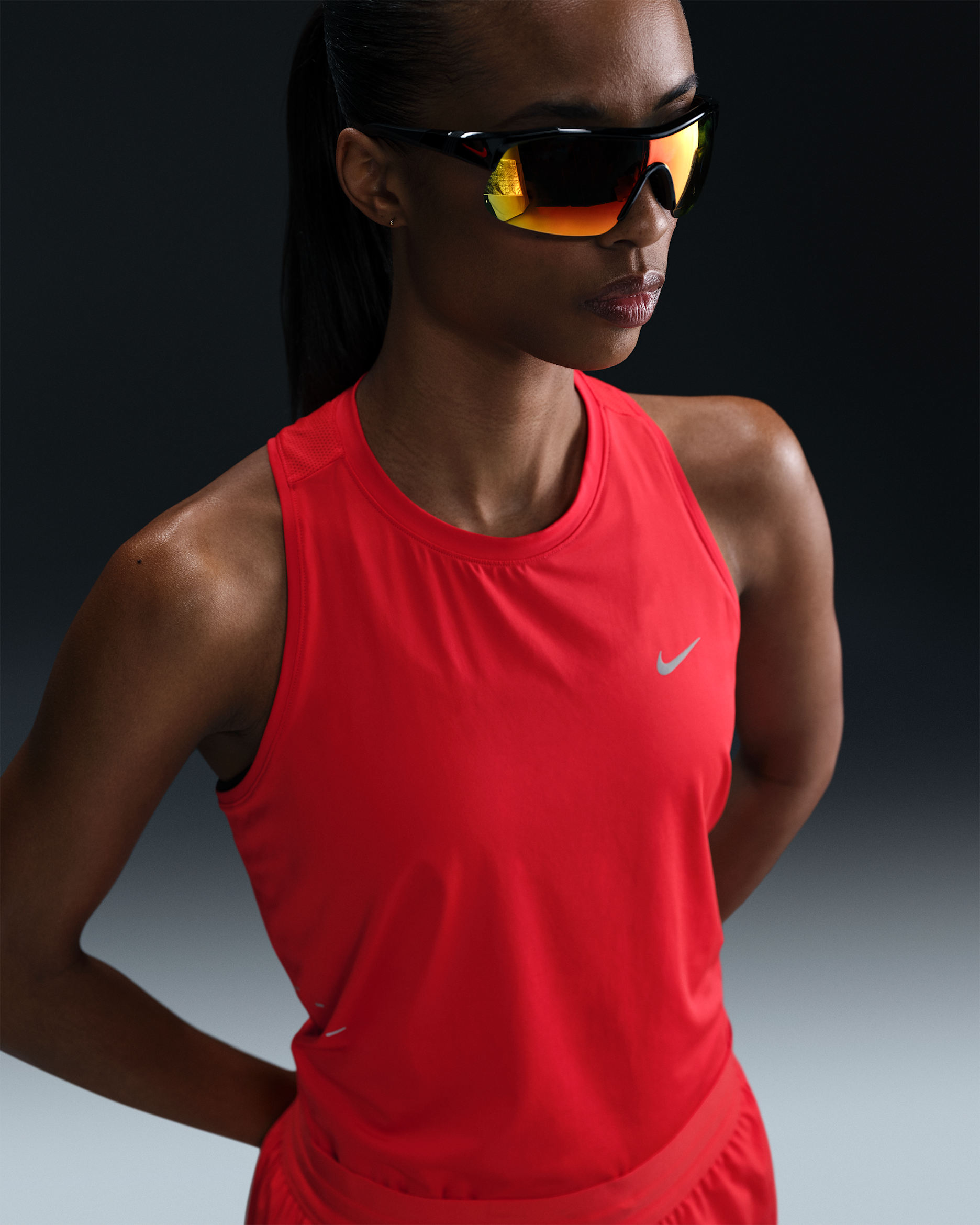 Red running singlet with open shoulders and a loose lightweight body