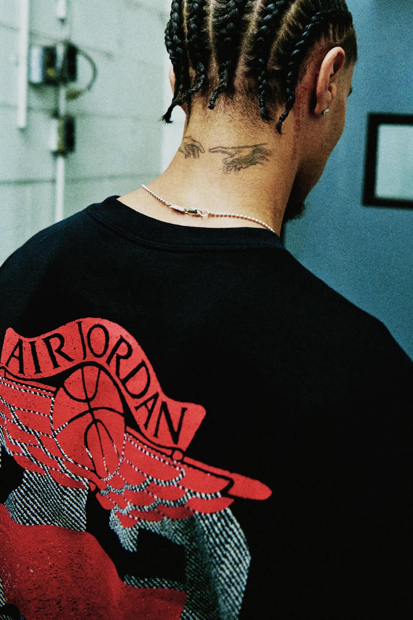 Back view of a black shirt featuring a large red graphic.