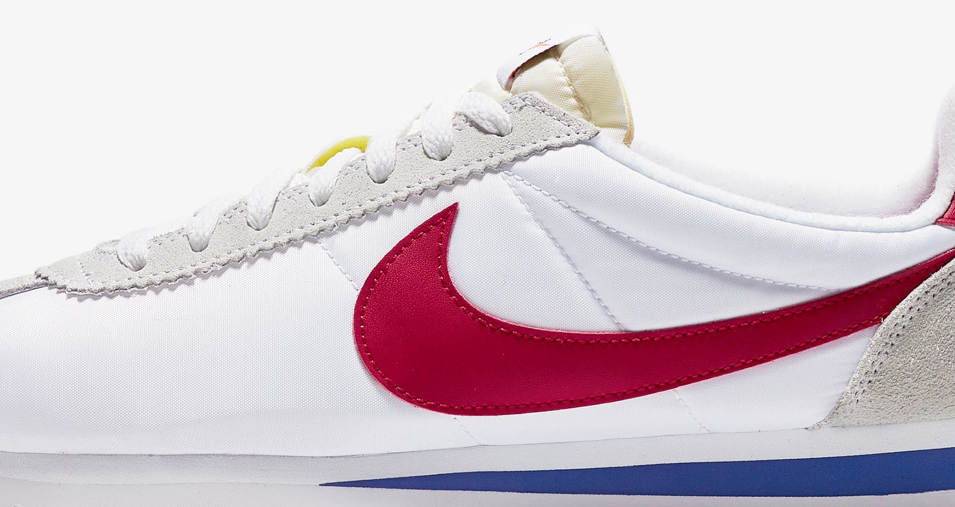 white nike cortez with red swoosh